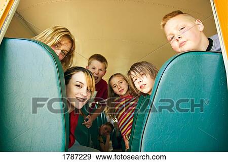Stock Photo - Children in a school bus. Fotosearch