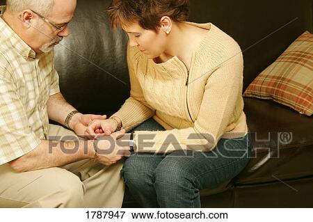 Couple in prayer View Large Photo Image Stock Photo - Couple in prayer. Fotosearch