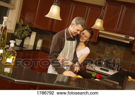 Couple in the kitchen View Large Photo Image Stock Image - Couple in the kitchen. Fotosearch