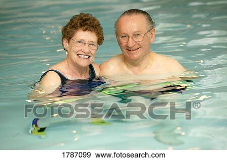 Couple swimming View Large Photo Image Stock Photo - Couple swimming. Fotosearch