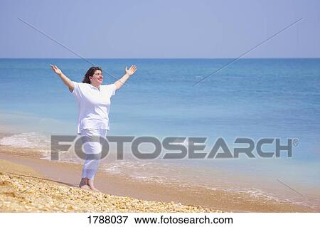 Stock Photo - Enjoying the beach. Fotosearch