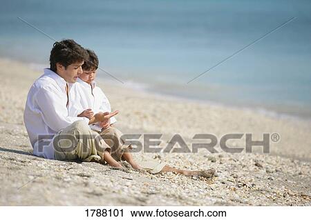 Father and son on beach View Large Photo Image Stock Image - Father and son on beach. Fotosearch