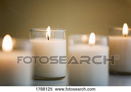 Stock Photography - Four white candles. Fotosearch