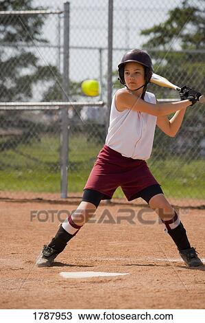 Stock Image - Girl playing baseball. Fotosearch