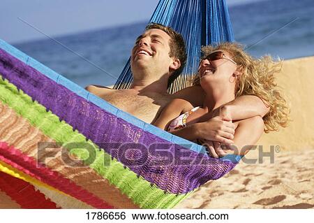 Stock Photograph - Happy couple in a hammock. Fotosearch
