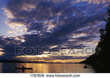Stock Photo - Kayaking at sunset, Galiano Island.. Fotosearch
