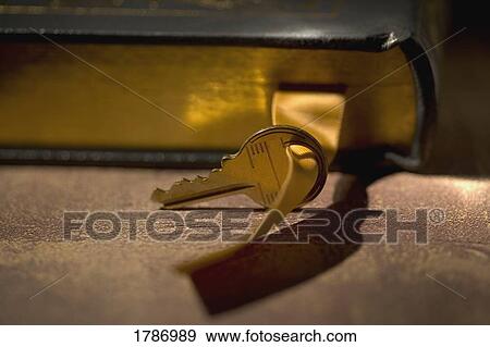 Stock Photo - Key with a book. Fotosearch
