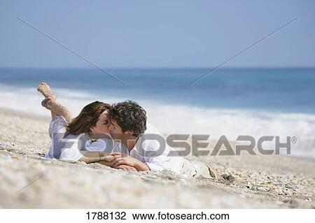 Stock Image - Kissing on the beach. Fotosearch