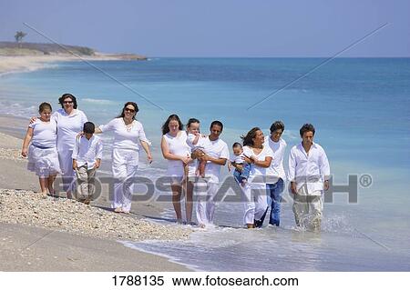 Stock Photography - Large family walking on beach. Fotosearch