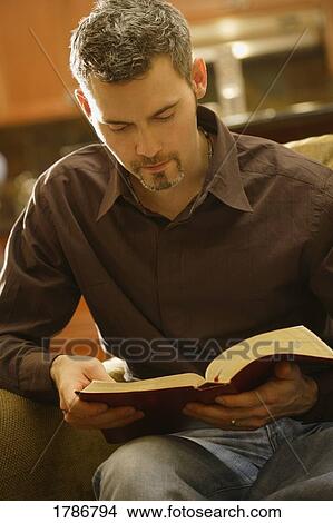 Man reading his bible View Large Photo Image Picture - Man reading his bible. Fotosearch