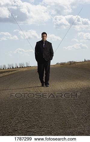 Stock Photo - Man walking on road. Fotosearch