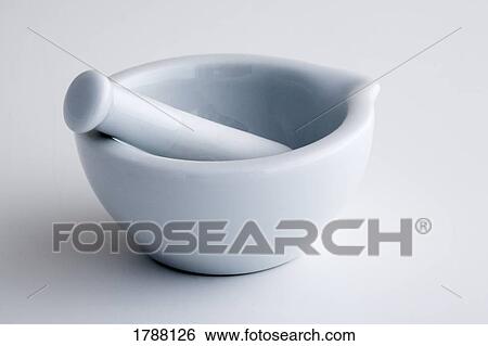 Stock Photograph - Mortar and pestle on white surface. Fotosearch