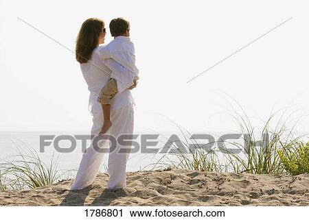 Stock Image - Mother and child on a beach. Fotosearch