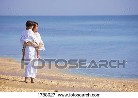 Stock Photo - Mother and son looking into water. Fotosearch