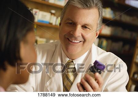 Stock Photo - Pharmacist and patient. Fotosearch