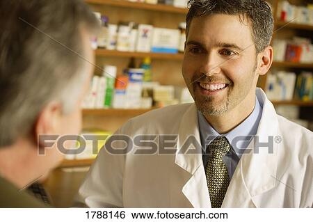 Pharmacist consulting customer View Large Photo Image Stock Photograph - Pharmacist consulting customer. Fotosearch
