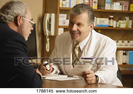 Pharmacist consulting View Large Photo Image Stock Photography - Pharmacist consulting. Fotosearch