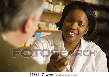 Stock Photo - Pharmacist in consultation. Fotosearch