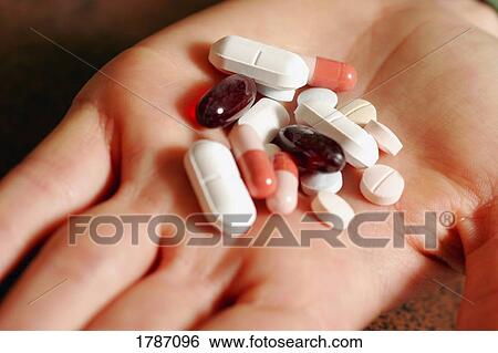 Stock Photograph - Pills in a hand. Fotosearch