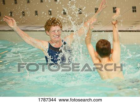 Senior woman and boy in swimming pool View Large Photo Image Picture - Senior woman and boy in swimming pool. Fotosearch