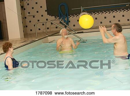 Stock Photo - Seniors playing ball in a pool. Fotosearch