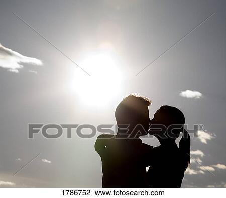 Silhouetted kiss View Large Photo Image Stock Image - Silhouetted kiss. Fotosearch