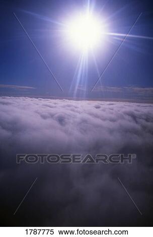 Stock Photography - Sun shining above the clouds. Fotosearch