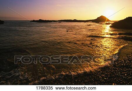 Stock Photography - Sunset on the beach of the Oregon Coast. Fotosearch
