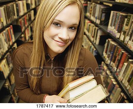 Stock Photo - Teenager at the library. Fotosearch