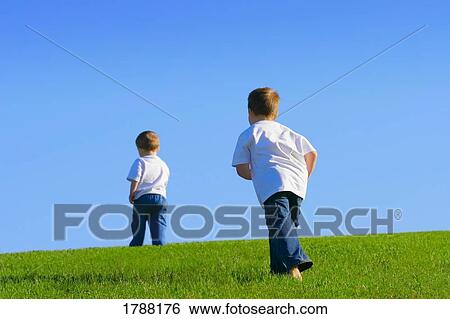 Two brothers walking away View Large Photo Image Stock Photograph - Two brothers walking away. Fotosearch