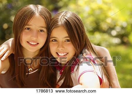 Stock Image - Two smiling sisters. Fotosearch