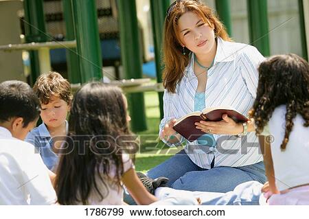 Stock Photo - Woman teaching children. Fotosearch