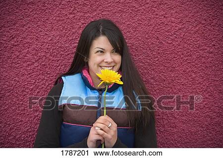 Stock Image - Woman with a flower. Fotosearch