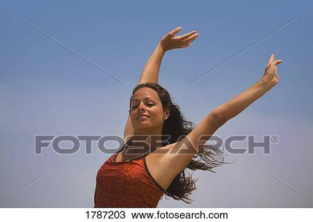 Stock Image - Woman with arms raised. Fotosearch
