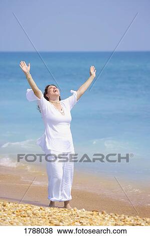 Stock Photo - Woman with her arms raised. Fotosearch
