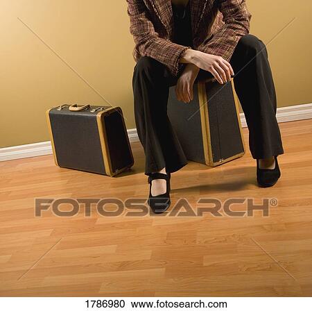 Stock Image - Woman with suitcases. Fotosearch