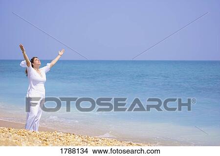 Women worshipping on the beach View Large Photo Image Picture - Women worshipping on the beach. Fotosearch