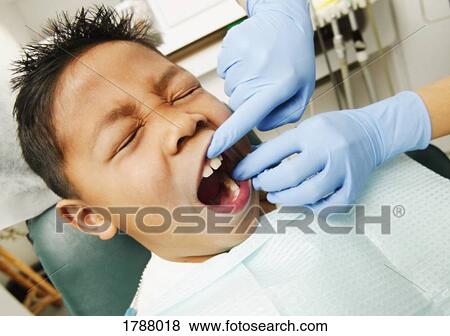 Young boy at the dentist View Large Photo Image Stock Photo - Young boy at the dentist. Fotosearch