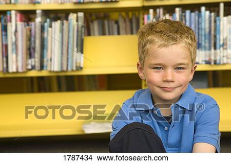 Young boy in library View Large Photo Image Picture - Young boy in library. Fotosearch