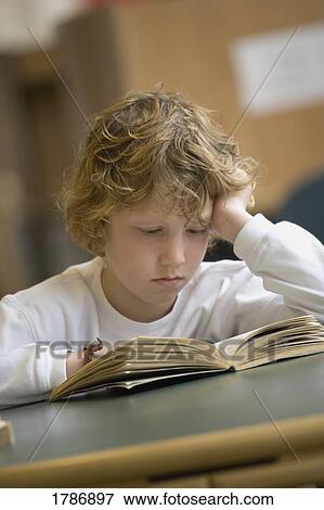 Young boy reading View Large Photo Image Stock Photo - Young boy reading. Fotosearch