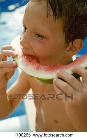 A boy eating watermelon View Large Photo Image Stock Photography - A boy eating watermelon. Fotosearch