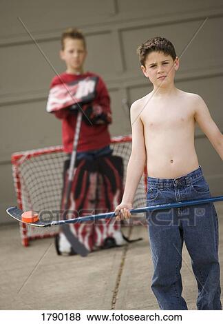 A boy rests a puck on the blade of his hockey stick View Large Photo Image Stock Photo - A boy rests a puck on the blade of his hockey stick. Fotosearch