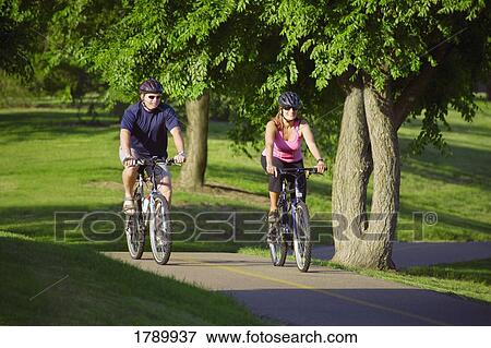 A couple on a bike ride View Large Photo Image Stock Photo - A couple on a bike ride. Fotosearch