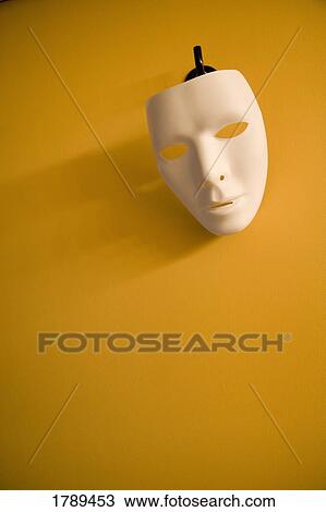 Stock Image - A mask hanging on the wall. Fotosearch