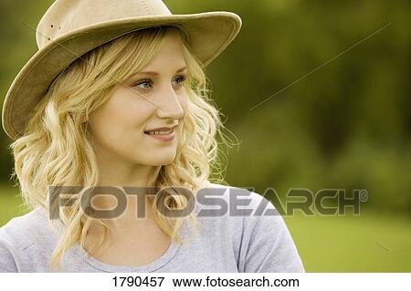 Stock Photo - A woman with a hat. Fotosearch