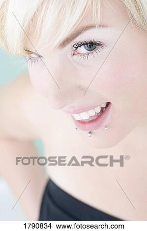 Picture - A woman with lip piercings. Fotosearch