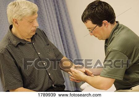 Assessing a patient View Large Photo Image Stock Photo - Assessing a patient. Fotosearch