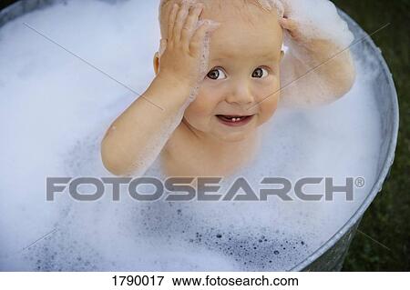 Stock Photo - Baby in washing basin. Fotosearch