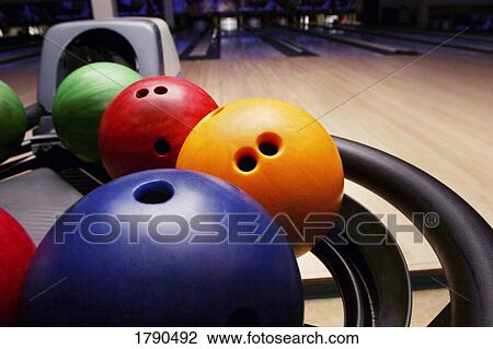 Stock Image - Bowling balls in bowling alley. Fotosearch