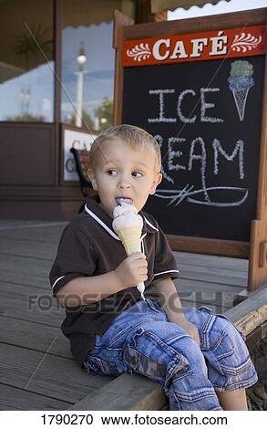 Boy eating ice cream cone View Large Photo Image Stock Image - Boy eating ice cream cone. Fotosearch